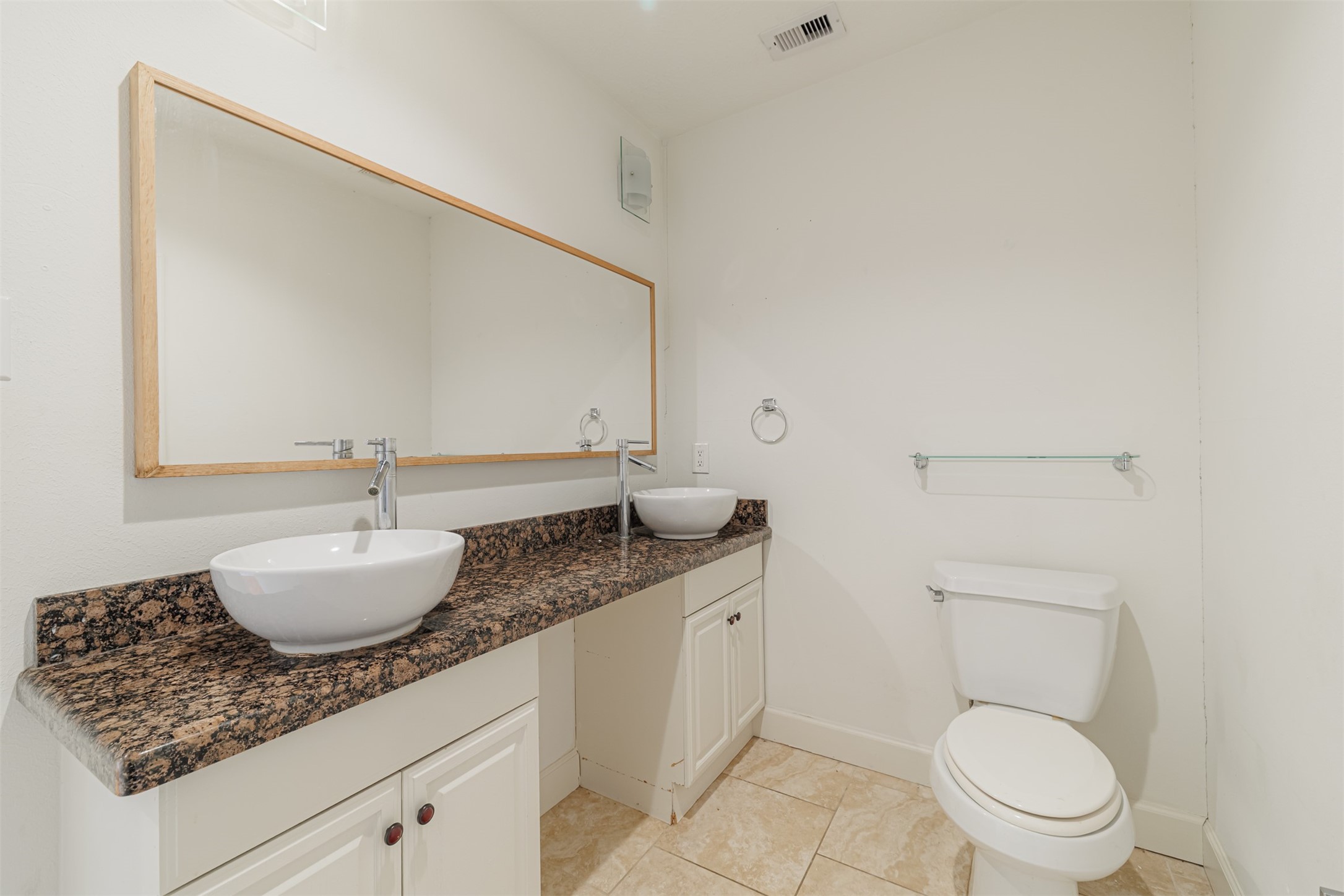 2438 Albans Road Houston, TX 77005 - Photo 22 of 34 a bathroom with a granite countertop toilet sink and mirror