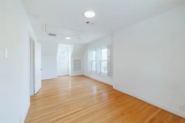 a bedroom with a large bed and a couch