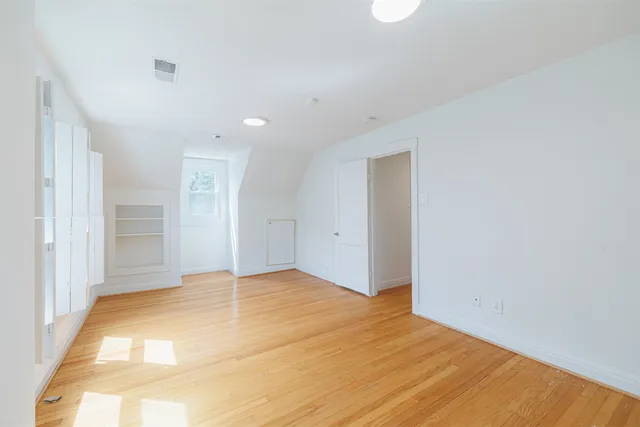 a bedroom with a bed and a desk