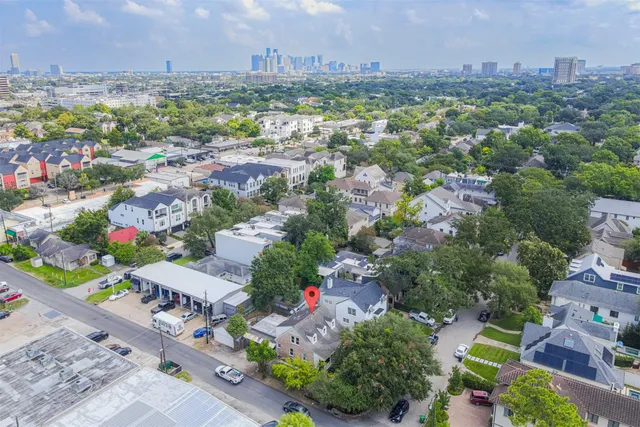 an aerial view of a house with a yard