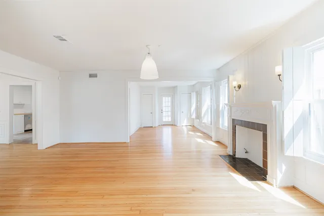 a view of an empty room and wooden floor
