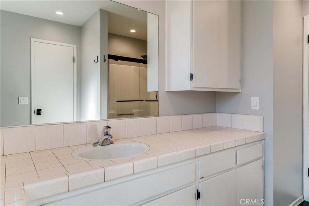 436 South Oak Park Boulevard, Unit 8 Grover Beach, CA 93433 - Photo 11 of 26 a bathroom with a sink and cabinets