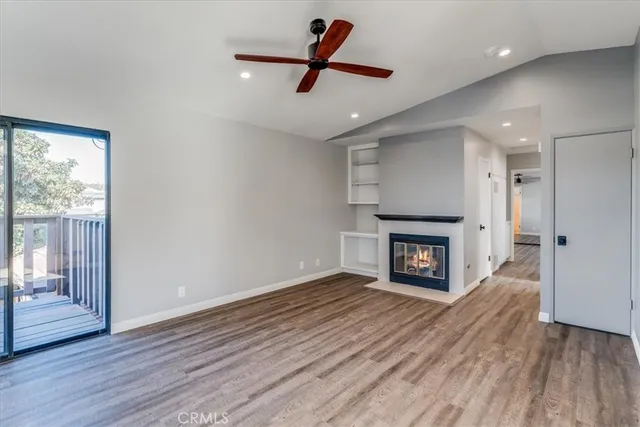 a living room with hard wood floors and a fireplace