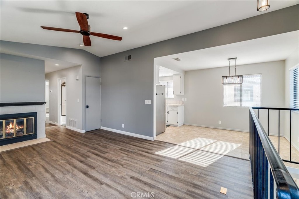 436 South Oak Park Boulevard, Unit 8 Grover Beach, CA 93433 - Photo 4 of 26 a view of an empty room with wooden floor fireplace and a window