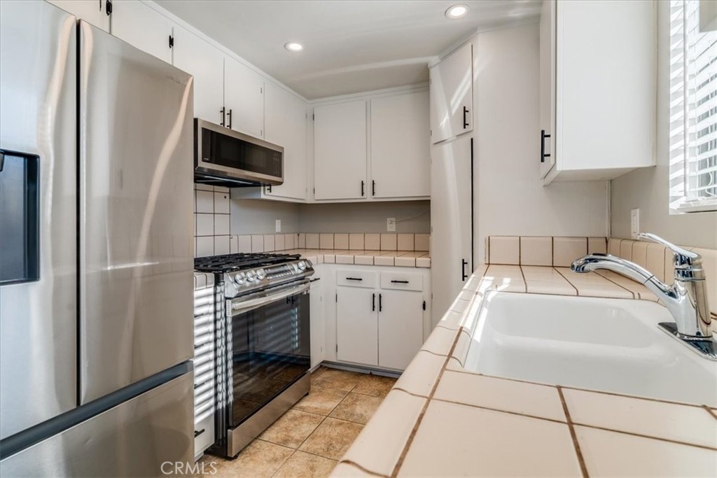 436 South Oak Park Boulevard, Unit 8 Grover Beach, CA 93433 - Photo 6 of 26 a kitchen with a sink stove and refrigerator