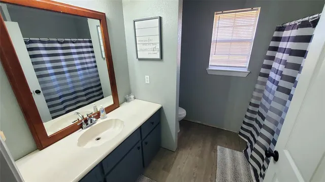 a bedroom with a bed and a television