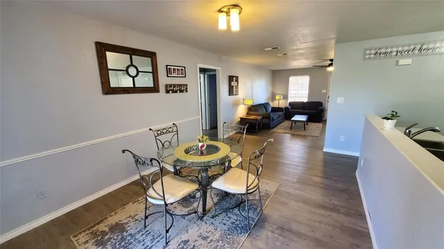 a view of a kitchen with sink and dishwasher with wooden floor