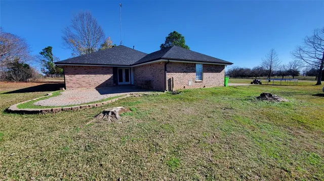 a view of a field of grass and trees