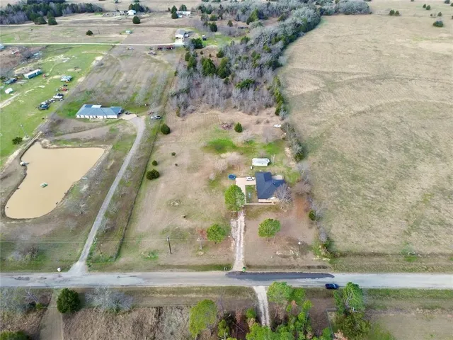 an aerial view of a residential houses with outdoor space