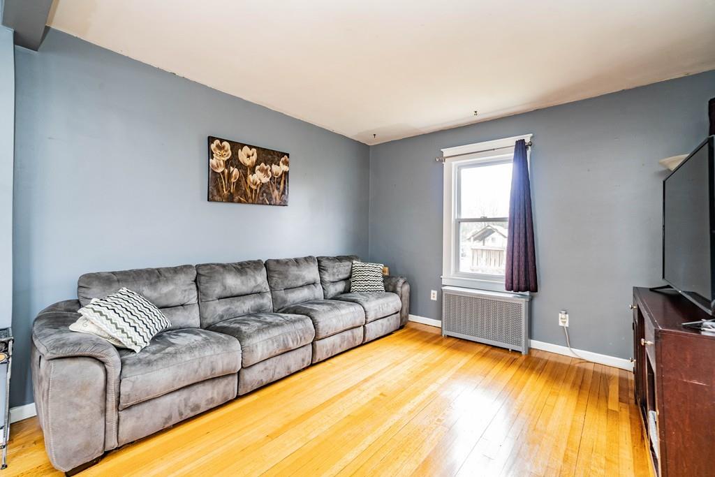 47 Richelieu Street Chicopee, MA 01020 - Photo 8 of 34 a living room with a couch and a flat screen tv