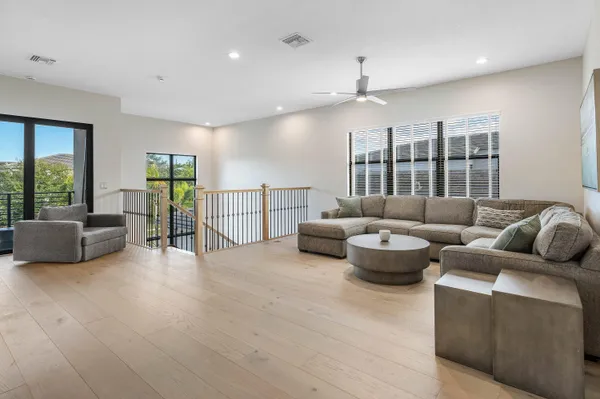 a bathroom with a shower sink vanity mirror and toilet