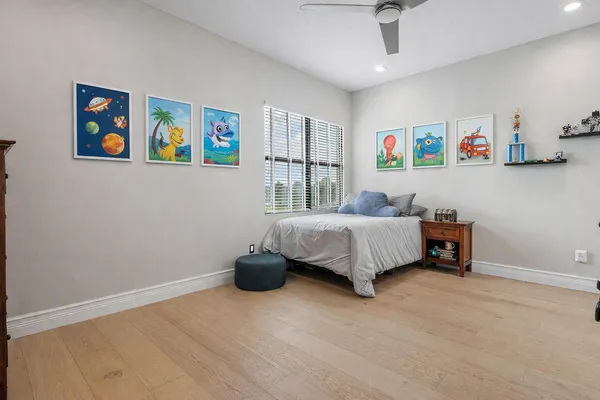 a view of a swimming pool with a yard and plants
