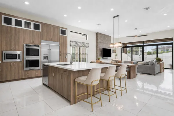a living room with furniture a window and a flat screen tv
