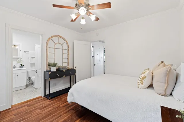 a bathroom with a bathtub shower sink vanity and mirror