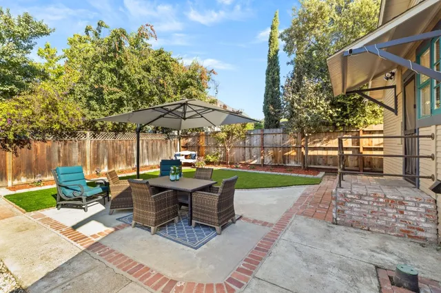 a view of patio with chairs and tables with a yard