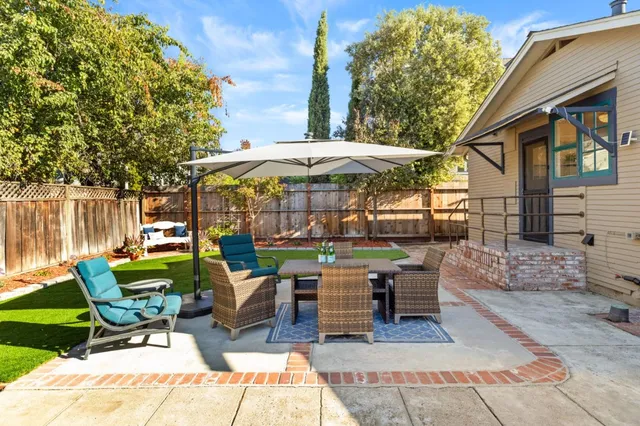 a view of a house with backyard porch and sitting area