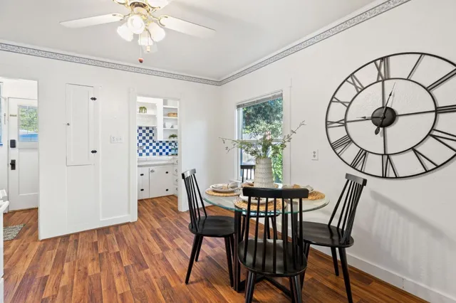a kitchen with a sink a stove a window and potted plants
