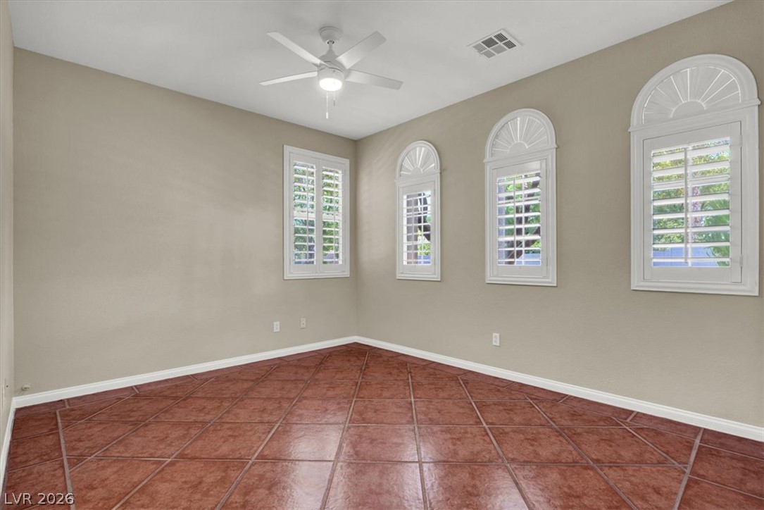 7308 Rustic Meadow Street Las Vegas, NV 89131 - Photo 11 of 27 Sun-filled room boasts ceramic tile flooring and multiple windows, providing a refreshing atmosphere.