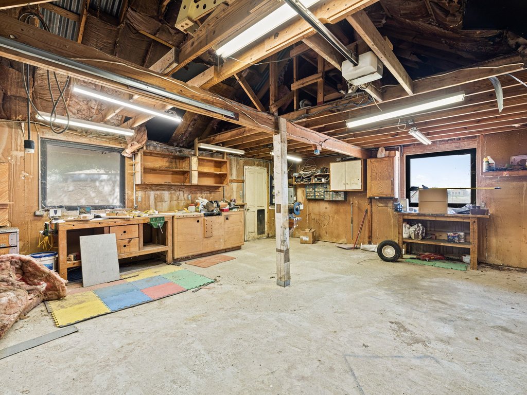 20416 Wilson Road Coupland, TX 78615 - Photo 24 of 39 Exposed wood framing and concrete flooring define this versatile workshop space.