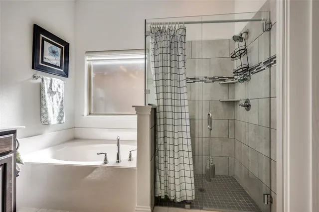 a bathroom with a bathtub and shower