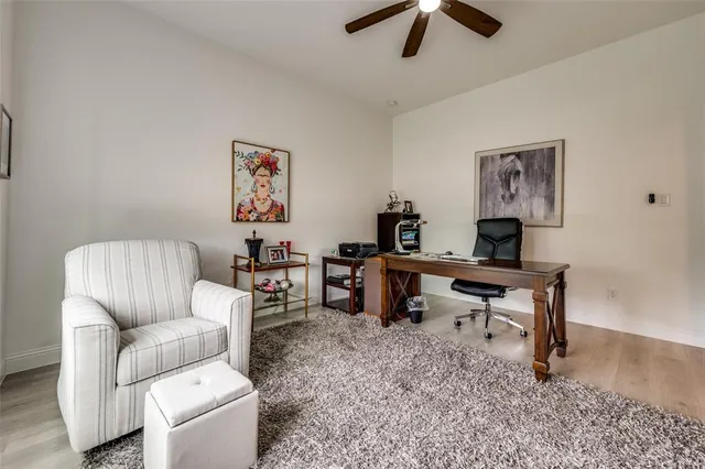a living room with furniture and a dining table