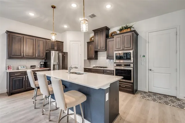 a large kitchen with a table and chairs