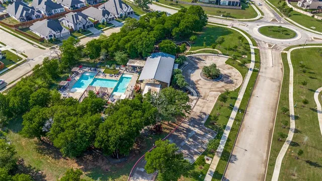 an aerial view of a house with a yard and trees