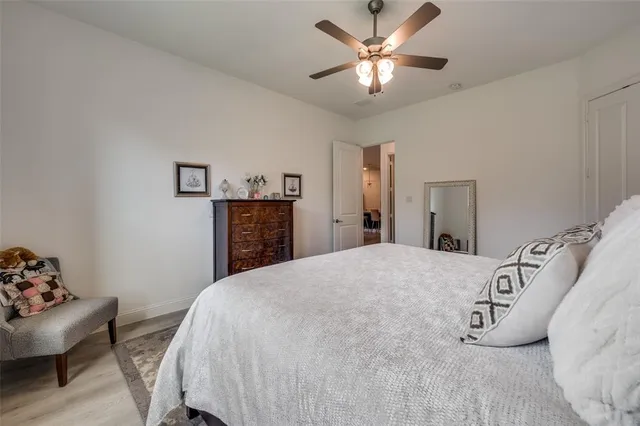 a spacious bedroom with a bed and a chandelier