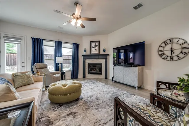 a living room with furniture a flat screen tv and a fireplace