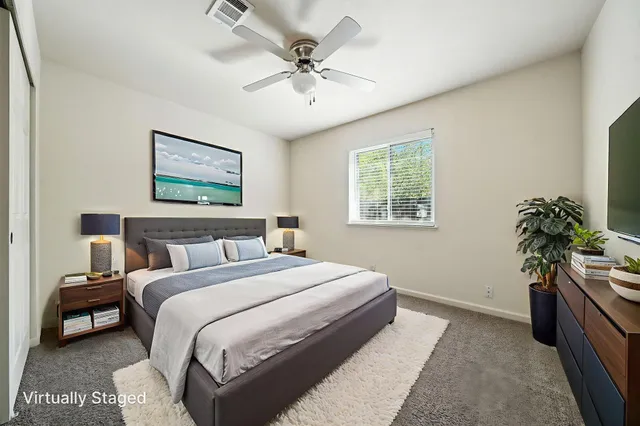a bedroom with a bed and a potted plant