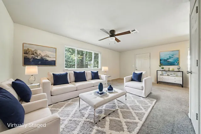 a living room with furniture and a large window