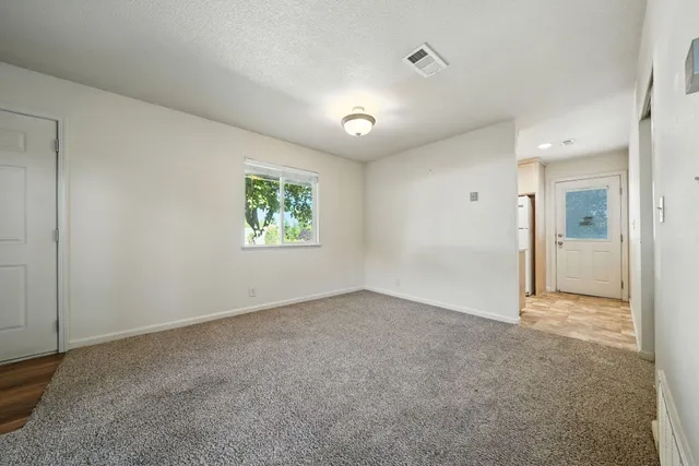 an empty room with windows and closet