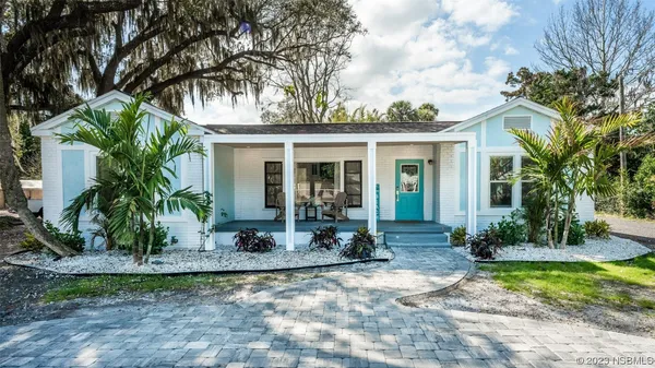 a front view of a house with porch and glass windows