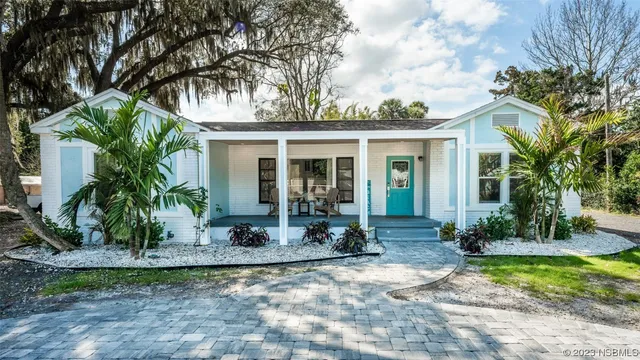 a front view of a house with porch and glass windows