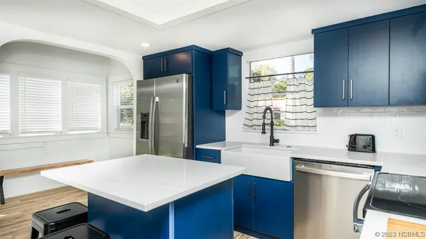 a kitchen with a refrigerator and a sink