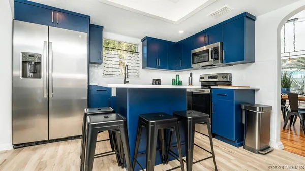 a kitchen with stainless steel appliances a refrigerator stove microwave and sink