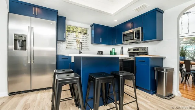 a kitchen with stainless steel appliances a refrigerator stove microwave and sink