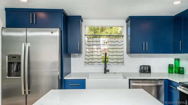 a view of a living room with a large window and wooden floor