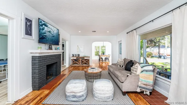 a view of a dining room with furniture and a chandelier
