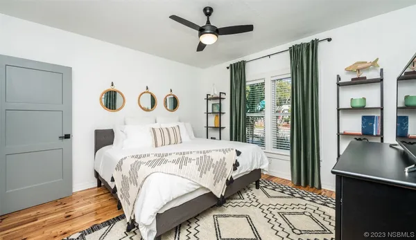 a bedroom with bed and a chandelier