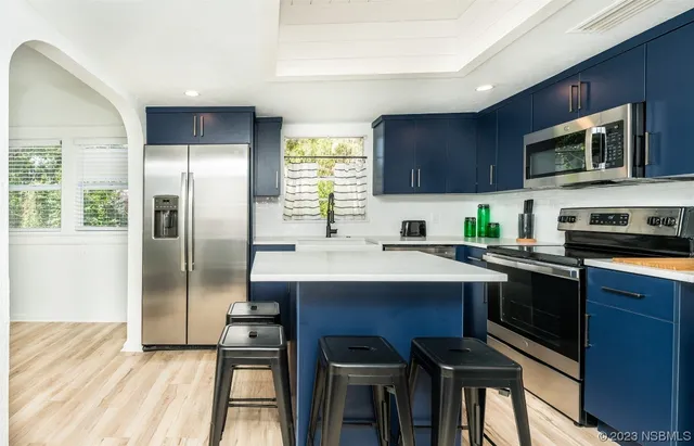 a kitchen with a sink stainless steel appliances and cabinets