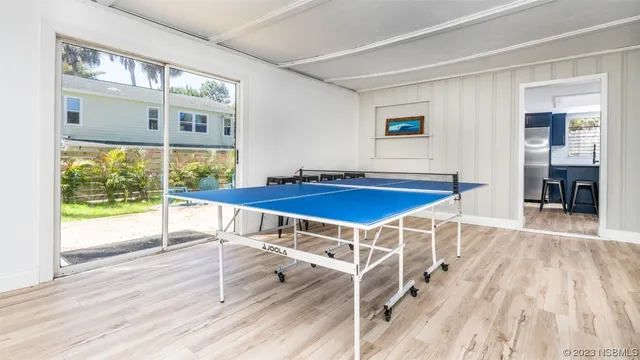 a view of a house with backyard porch and sitting area