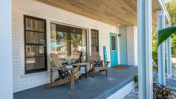 a kitchen with kitchen island a counter top space appliances and a refrigerator