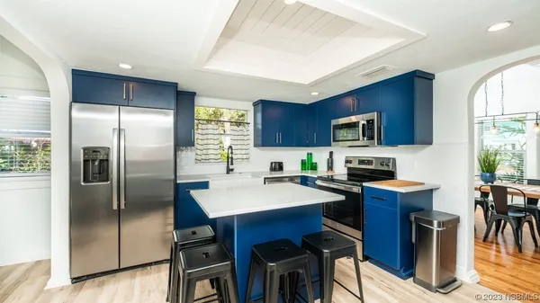 a kitchen with stainless steel appliances a stove a microwave a sink and cabinets