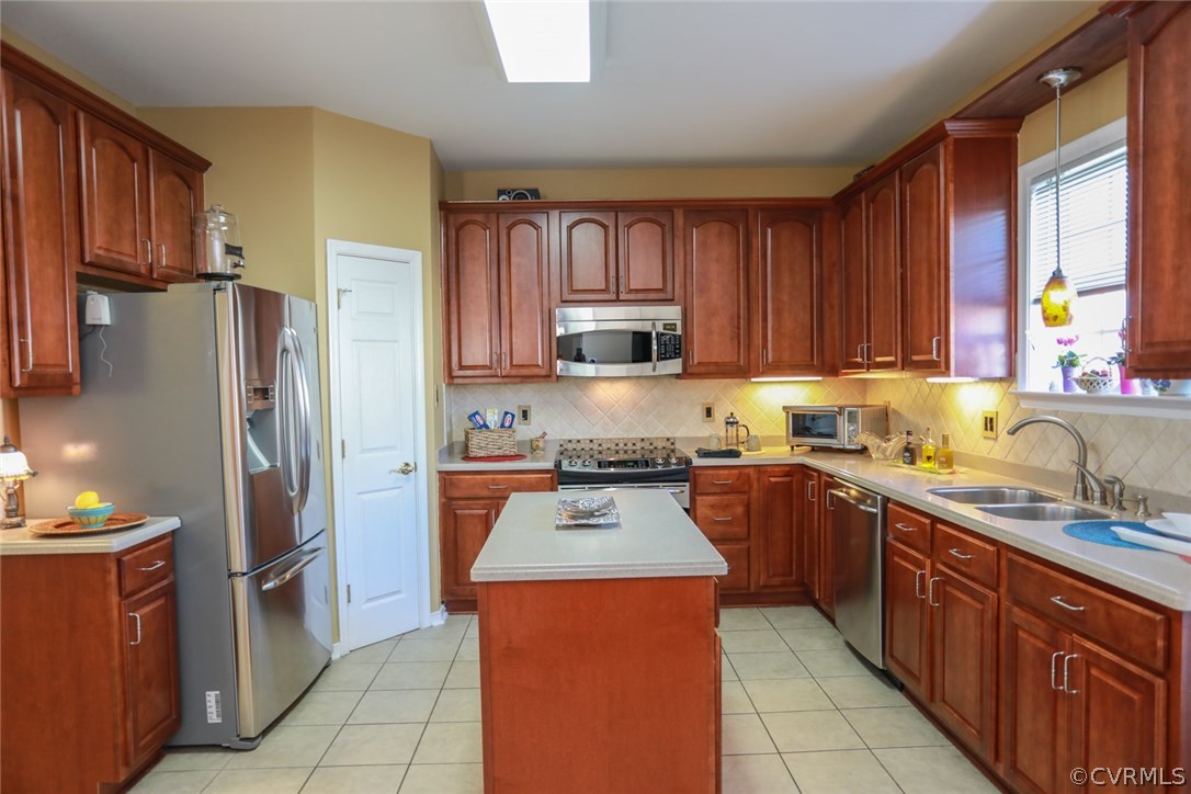 3006 Burley Ridge Terrace Chester, VA 23831 - Photo 14 of 37 a kitchen with stainless steel appliances granite countertop a stove refrigerator sink and microwave