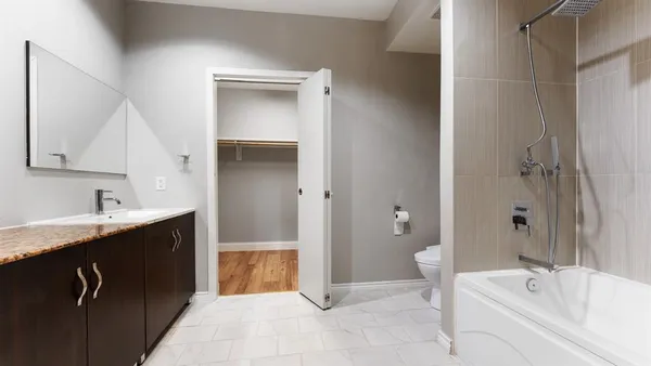 a bathroom with a tub sink and mirror