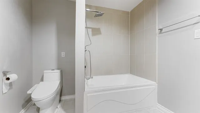 a bathroom with a toilet and a shower