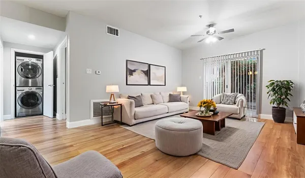 a living room with furniture and wooden floor