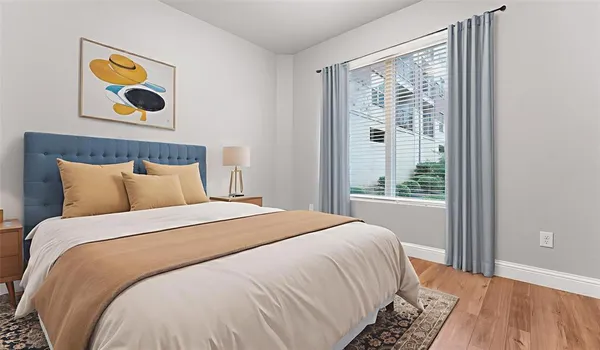 a large bed sitting in a bedroom next to a window