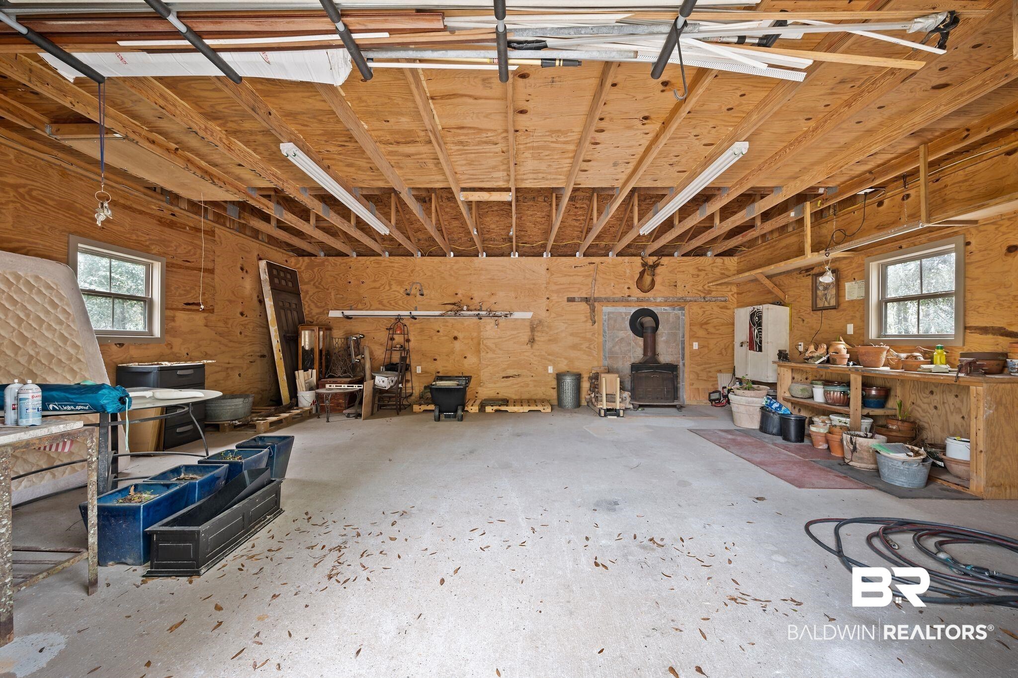 7850 Yorkhaven Road Mobile, AL 36695 - Photo 51 of 57 Garage featuring a wood stove and a workshop area